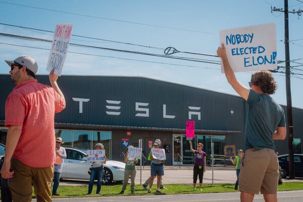 Activists from the ResistAustin movement gather outside a Tesla dealership in Austin earlier this month.
