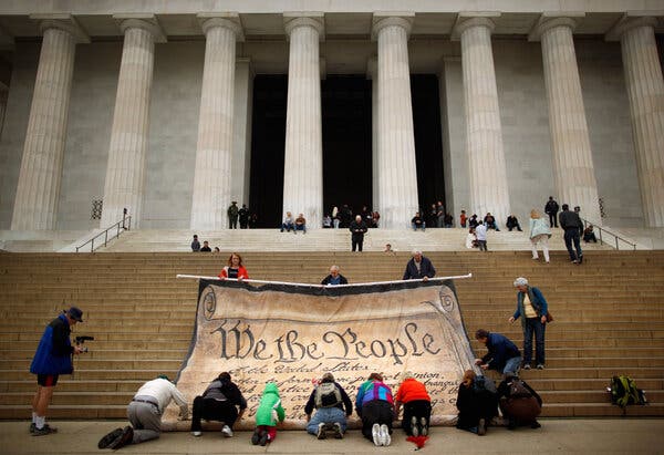 Volunteers gathered at the Lincoln Memorial in Washington, D.C., in 2010 to roll up a banner displaying the preamble to the U.S. Constitution.
