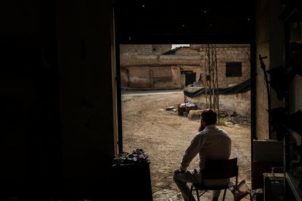 A foreign combatant who fought alongside Syrian rebel factions that toppled Bashar al-Assad’s regime, pictured at his shop in Binnish, Syria.