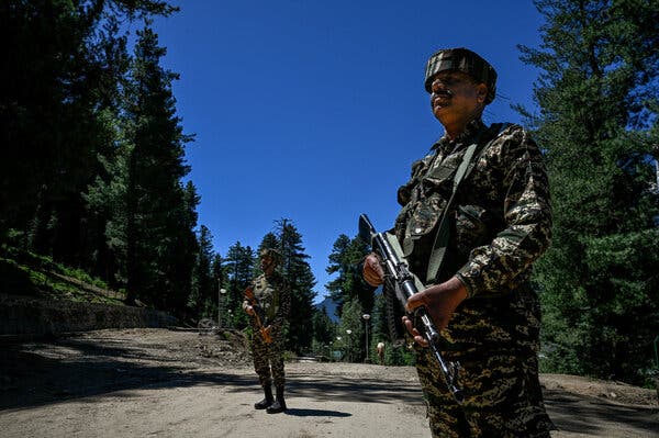 Indian security forces stand guard near Baisaran Valley in Pahalgam, Kashmir, following a recent terrorist attack.