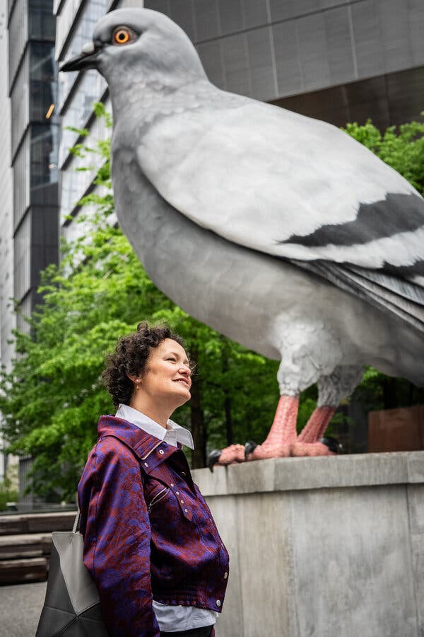 Cecilia Alemani pictured at the High Line alongside 'Dinosaur,' a sculpture by Iván Argote displayed in the park.