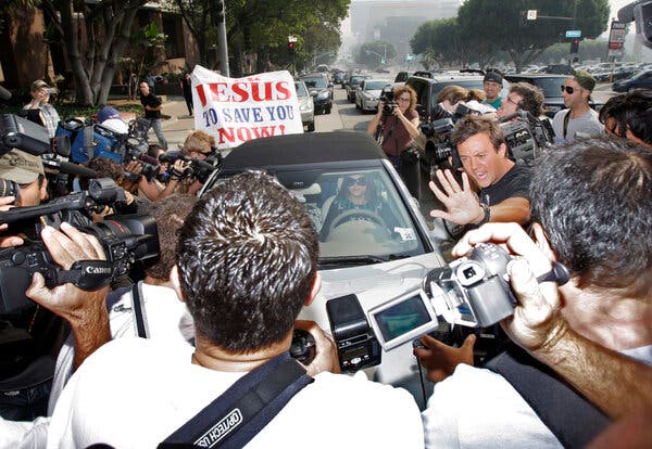 A swarm of reporters and photographers surrounds Britney Spears during a 2007 court appearance for a child custody hearing.