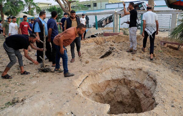 Palestinians inspect damage from an Israeli airstrike near the European Hospital in Khan Younis, Gaza Strip, on Tuesday.
