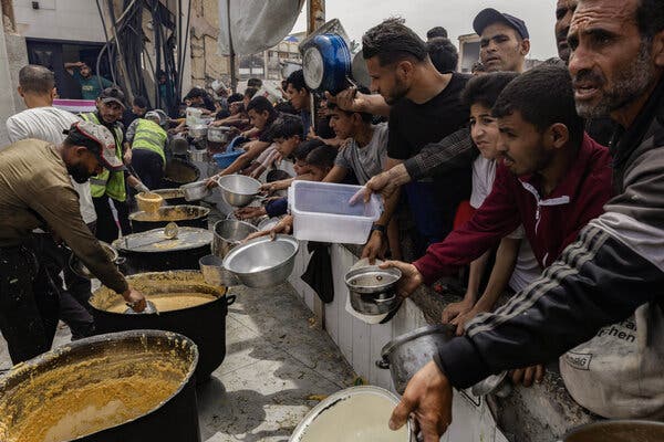 Palestinians queueing for food distribution at the Jabaliya camp in northern Gaza Strip in April. Food supplies have dwindled since Israel imposed an aid blockade in March.