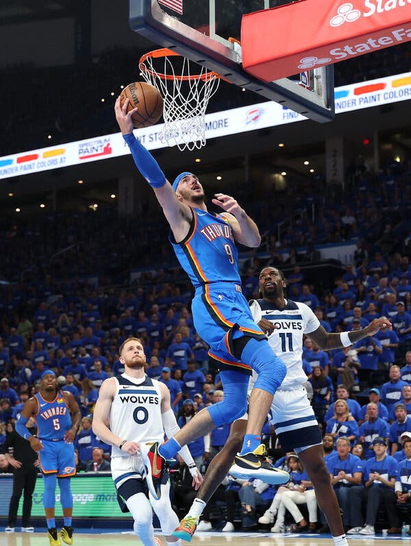Alex Caruso rises for a layup during Game 2 of the Western Conference finals, highlighting the passionate fanbase of the Oklahoma City Thunder.
