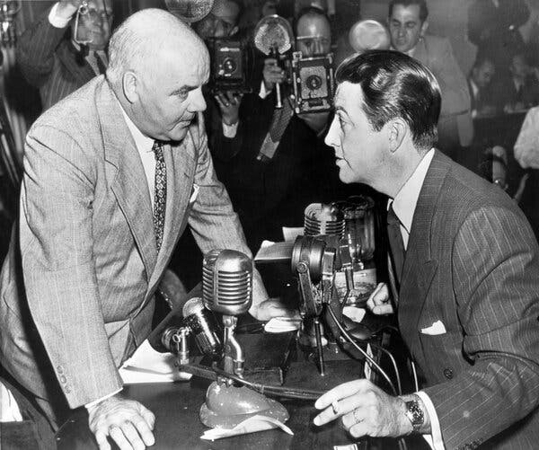 Representative J. Parnell Thomas, chairman of the House Un-American Activities Committee, in discussion with actor Robert Taylor in 1947.