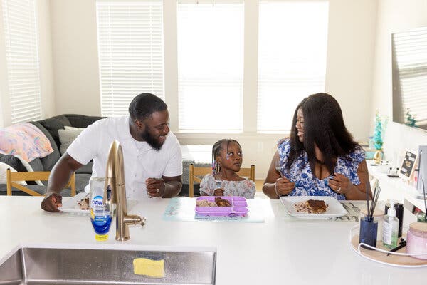 Tia Hodge with her husband Jason and daughter Naveah at their Austell, Georgia home. She utilizes a buy now, pay later service to help manage grocery costs.