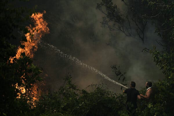 Firefighters combat a wildfire on the outskirts of Patras, Greece, on Wednesday.