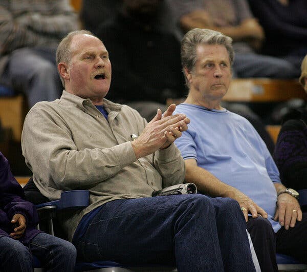 Stan Love (left) in 2006 alongside Brian Wilson of the Beach Boys, attending a high school basketball game featuring Mr. Love’s son, a future Miami Heat standout. Earlier, Stan served as Wilson’s caretaker and bodyguard.