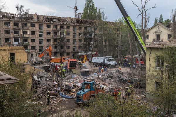 Rescue personnel at the scene of an apartment building destroyed by a Russian missile strike in Kyiv on Thursday.