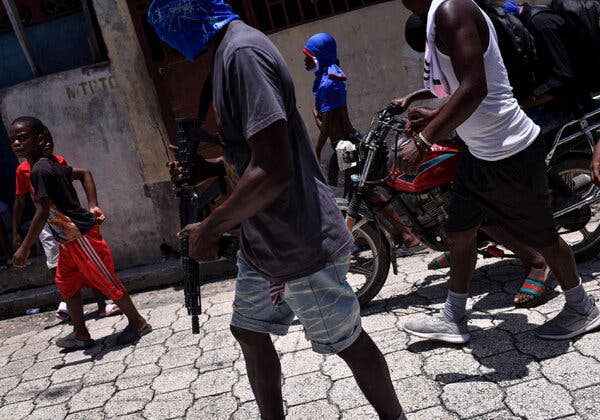 Members of armed gangs patrolling the streets of Port-au-Prince last year.