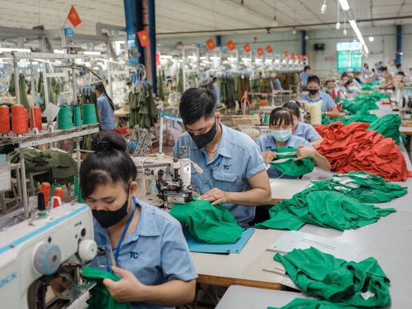 Garment workers at Thanh Cong Textile Garment factory in Ho Chi Minh City produce clothing along a busy assembly line.