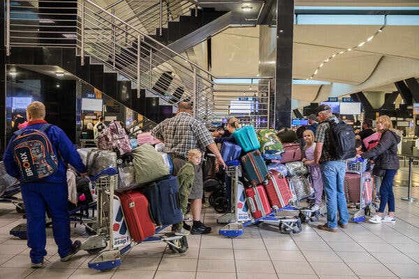 Afrikaners gather at Johannesburg’s OR Tambo International Airport preparing to depart for the United States on Sunday.